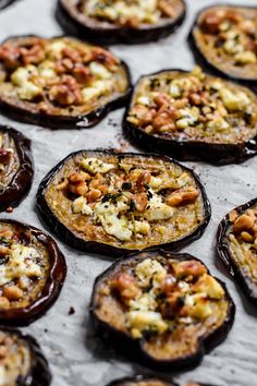 baked stuffed eggplant with nuts and cheese on a baking sheet, ready to be eaten