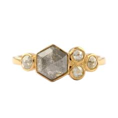 a yellow gold ring with three diamonds on it