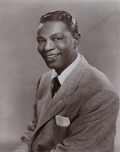 a black and white photo of a man in a suit