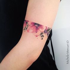 a woman's arm with pink flowers on it