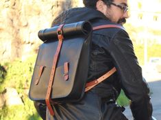 "Roll top leather backpack laptop men ideal for city or business travel, this black laptop bag is functional and classic utilitarian for everyday use. This Minimal leather laptop backpack offers modern functionality plus a touch of refinement that distinguishes it from the classic utilitarian roll-top backpack. Dimensions: 17.70\" H when top stretched (45 cm) 14.17\" H when top rolled (36 cm) 11.81\" W (30 cm) 2.76\" D (7 cm) Specifications: *This leather backpack has one deep main pocket for your laptop, tablet, documents and other objects. *Two twin minimal exterior pockets wide enough for easy access to quickly locate the items which you need to have at hand. *On the back of this laptop backpack there is a more discreet pocket with zipper closing to store documents, keys, etc. Minimal b Leather Messenger Bag Men, Biking Backpack, Leather Backpack For Men, Leather Laptop Backpack, Backpack Laptop, Top Backpacks, Leather Rucksack, Laptop Rucksack, Leather Travel Bag