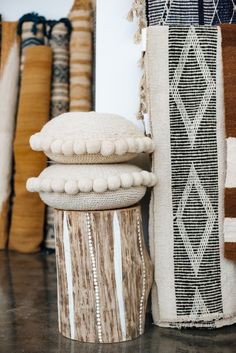 several rugs and pillows on display in a room