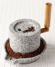 there is a small cake that has been made out of cement and coffee beans on top