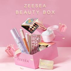 a pink box filled with beauty products on top of a white table next to a pink background