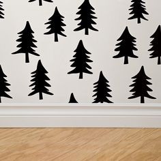 the wall is decorated with black and white trees