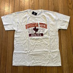 White Virginia Tech Tshirt, Youth Xl, Brand New White Collegiate Tops For School, White School Spirit T-shirt, White Collegiate Screen Print Top, White Collegiate Top With Screen Print, White Collegiate Top With Text Print, White Graphic Tee For College, Collegiate White T-shirt With Text Print, White Collegiate T-shirt With Text Print, White Collegiate T-shirt With Graphic Print