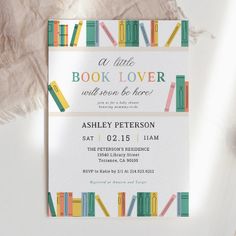 an image of a book lover baby shower party with books on the shelf and tassels