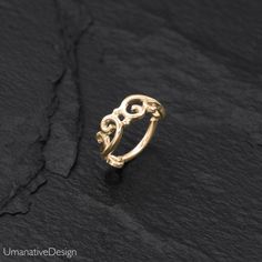 Beautiful gold nose ring. Tribal and delicate design, can be worn as a nose ring, earring for the tragus, helix, earlobes & as a septum ring as well. Material: 14k Gold plated on Sterling silver base Wire Thickness: 0.8 mm - 20g Inner Diameter Of The Ring: 7mm - 0.27Inc *Nickel-free For other nose rings- We offer a range of septum rings, for pierced and non- pierced noses, made of different materials. You can find fake septum rings at this link- https://www.etsy.com/shop/Umanativedesign?sect Adjustable Gold Elegant Septum Ring, Elegant Adjustable Gold Septum Ring, Elegant Small Hoop Hypoallergenic Septum Ring, Elegant Hypoallergenic Small Hoop Nose Rings, Elegant Hypoallergenic Small Hoop Septum Ring, Elegant Nickel-free Hoop Nose Ring, Dainty Small Hoop Cartilage Earrings For Wedding, Minimalist 14k Gold Nose Ring For Wedding, Elegant Small Hoop Gold Septum Ring