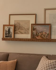 a living room filled with furniture and pictures on the wall