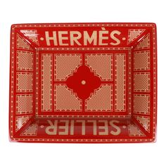 a red and gold serving tray with the words hermess on it