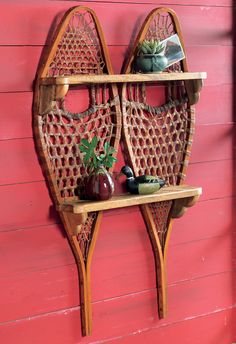 a wooden shelf with two baskets on it and a potted plant next to it