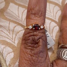 a woman's hand with two rings on it and a ring in the middle