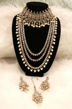 Handcrafted with love to give a real traditional look for this set beautifully studded with polki stones and pearls give a royal look. Includes: Choker, Rani Haar, Earrings, and Tikka Elegant Bridal Earrings With Stone Work And Pearl, Elegant Pearl Bridal Earrings With Stone Work, Elegant Pearl Jewelry Set With Stone Work, Formal Pearl Jewelry With Stone Work, Pearl Jewelry With Tilla For Reception, Elegant Pearl Jewelry With Meenakari, Elegant Meenakari Pearl Jewelry, Bollywood Style Pearl Jewelry For Formal Occasions, Festive Pearl Bridal Earrings With Stone Work