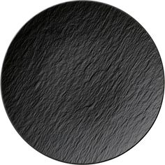 a round black slate plate on a white background