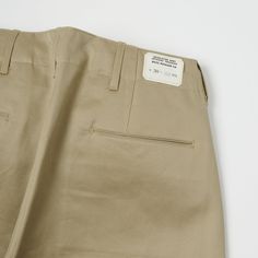 This brand new wide fitting chino from Buzz Rickson’s has been inspired by a 1942, US Army issue chino. The timeless vintage shape has been complimented by a high rise, and plenty of authentic detailing. Designed for comfort and ease of movement, the wide leg opening of this model makes this trouser very breathable and easy to wear. Known for their attention to detail, Buzz Rickson’s have custom manufactured a set of metal US Army sew in buttons for added authenticity. Two side entry pockets and Trousers Details Menswear, Buzz Rickson, Pant Details, Trousers Details, Formal Pants, French Army, Pants Details, Cotton Chinos, Sew In