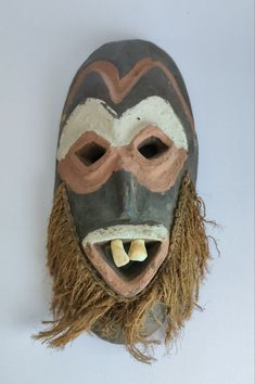 "This is a wonderful antique African Malindi Mask from the Congo. Masks like this are decorated with clay, hemp or raffia, real cows teeth, all natural pigments. The masks were used to scare away evil spirits. A very creative and unique mask. This would look great on any wall or as a collection. The item is very old so shows some age, and Natural Wear, early 20th century. 11.5\"  x  5\" *Item location: Phuket, Thailand **will be very well packed, worldwide shipping within 1-3 business days Pleas West African Masks, Voodoo Mask, Mahjong Set, Unique Masks, Tiki Mask, Natural Pigments, African Mask, Masks Art, Phuket Thailand