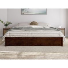 a bed sitting on top of a white rug next to a wooden headboard and foot board