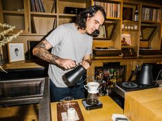 a man pours coffee into a cup