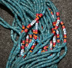 "Antique Necklace 579. Authentic Konyak Naga Long \"Royal\" Chief's Clan, Old blue Glass Trade Bead Necklace with Macrame Clasp and Attached Old Chank Shell Adornment Showing Increased Status. \"Royal\" center of special chevron, mustard, white heart and other beads usually seen in higher status collars, bibs and belts. Excellent condition. The piece has 45 strands of beads and is 32 \"long. Beads all acquired in trade, from Europe and India, from late 19th to mid 20th century. Shell, from the I Traditional Hand-strung Blue Jewelry, Traditional Spacer Beads For Festivals, Traditional Hand-strung Blue Beaded Bracelets, Traditional Large Blue Beads, Traditional Blue Beaded Bracelets, Traditional Blue Beaded Bracelets For Festivals, Traditional Blue Beaded Necklaces, Traditional Blue Beaded Bracelets With Large Beads, Artisan Blue Beaded Necklaces For Festivals