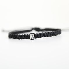 This lovely bracelet is made of black cord and sterling silver cube initial. It is adjustable. Please choose if the recipient is a Kid, a Woman, or a Man The bracelet is Waterproof Interested in other colors, please send me a message. I can make a custom order for you Adjustable Everyday Jewelry With Initials, Everyday Adjustable Jewelry With Initials, Modern Black Braided Bracelets For Gift, Modern Black Braided Bracelets As Gift, Modern Black Braided Bracelet Gift, Modern Black Braided Bracelet As Gift, Modern Adjustable Jewelry With Initials, Modern Adjustable Initials Jewelry, Black Sterling Silver Braided Bracelet Gift