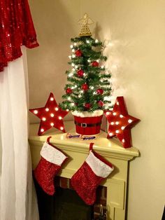 a small christmas tree with red and white stockings