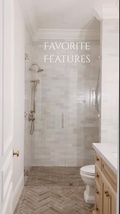 a bathroom with white walls and wood floors, an open shower door and a chevron tile floor