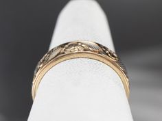 This stunning vintage wedding band features a beautiful floral pattern with classic, hand engraved flowers and leaf motifs. The rounded edge makes for a sleek profile on the finger, and the low setting and smooth center is comfortable on the hand. Metal: 14K Yellow Gold Width of Band: 5.9 mm Height off Finger: 1.5 mm Ring Size: 6.75 Marks: "14K D" Stamped on the inside band 14k Gold Wedding Band, Engraved Flower, Flower Band, Stacking Bands, Vintage Wedding Band, Vintage Band, Gold Floral, Gold Flowers, Vintage Pattern