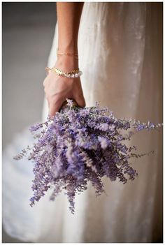 a woman holding a bouquet of flowers in her hand on the web page for despefllowes