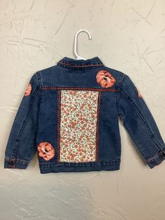 This is a childs 7 For All Mankind blue jean jacket size small.  Hand embroidered with vintage fabric, patches and embroidery. Long Sleeve Denim Jacket With Patches, Spring Cotton Outerwear With Embroidered Patch, Embroidered Cotton Denim Jacket For Fall, Cute Medium Wash Cotton Denim Jacket, Medium Wash Cotton Denim Jacket With Floral Embroidery, Medium Wash Denim Jacket With Floral Embroidery, Floral Embroidered Medium Wash Denim Jacket, Floral Embroidered Cotton Denim Jacket In Medium Wash, Cute Fitted Denim Jacket With Pockets