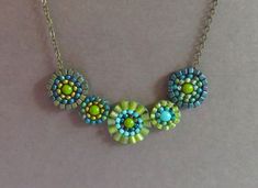 A beautiful combination of tiny colorful glass beads - some matte, some shiny - are hand stitched into mandala coins, then joined together and hung from antique bronze chain. Colors include aqua, turquoise, lime green, metallic green, chartreuse and metallic blue. Lobster clasp closure. Necklace is 16 inches long with a 3 inch extender chain, which allows a maximum length of 19 inches. Lead and nickel free. My own original design. Orders $35 and up ship free. Beaded Mandala, Blue Lobster, Green Chartreuse, Green Beaded Necklace, Necklace Bead, Aqua Turquoise, Wedding Jewellery Necklace, Metallic Blue, Glass Bead Necklace