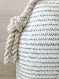 a white rope wrapped around the back of a pillow