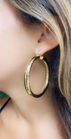 18kt Gold Filled Large Hoop Earrings- Tarnish Resistant; Hypoallergenic Hoop Size: 60mm Width: 6.5mm Clasp: Hinged Material: 18 Karat Gold Filled, Hypoallergenic. Tarnish Resistant. Gold-filled does not de-laminate or peel like Gold plated Jewelry nor does it tarnish as readily as silver. Generally speaking, gold filled is better quality and will have a much longer lasting color than plated jewelry. We recommend keeping abrasive chemicals away from the jewelry for the items to last. Thank you fo Big Hoop Earrings Aesthetic, Hoop Earrings Aesthetic, Hoop Earrings Big, Thick Gold Hoop Earrings, Hoop Earrings Chunky, Thick Gold Hoops, Bamboo Hoop Earrings, Chunky Hoop Earrings, Earrings Big