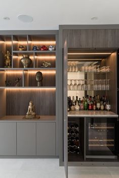 a wine cellar with many bottles and glasses on the shelves, along with other items