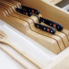 three knives are in a wooden holder