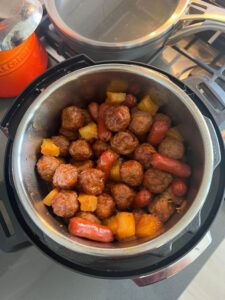 meatballs and carrots are cooking in an instant pot