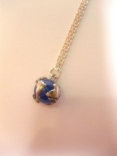 "Earth Globe Necklace Please review shipping policies (International customers, especially Blue Glass mounted with metal Earth map Size - 5/8\" diameter Chain: - Silver Plated over Brass CHOOSE YOUR CHAIN LENGTH from drop down menu tool. To view more items from our shop: https://www.etsy.com/shop/FashionCrashJewelry?ref=hdr_shop_menu INTERNATIONAL CUSTOMERS, PLEASE REVIEW MY SHIPPING & POLICIES FOR SHIPPING TIMES, AND POSSIBLE CUSTOM/DUTY FEES! You may view my shop policies here: http://www. Blue Round Pendant Jewelry With Chain, Blue Round Pendant Chain Jewelry, Blue Jewelry With Chain And Round Pendant, Blue Jewelry With Round Pendant Chain, Blue Metal Charm Necklace With Lobster Clasp, Blue Round Chain Necklace, Nickel-free Blue Metal Charm Necklaces, Nickel-free Silver Necklaces For Christmas, Nickel-free Silver Necklace For Christmas