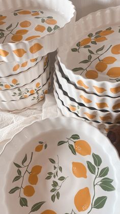 several plates with oranges painted on them