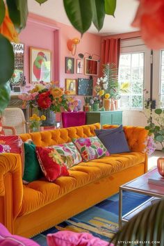 a living room filled with lots of colorful furniture and flowers in vases on the wall