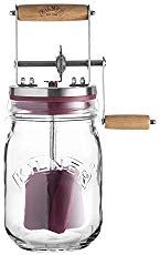 a glass jar with two wooden spoons in it and some sort of device attached to the lid