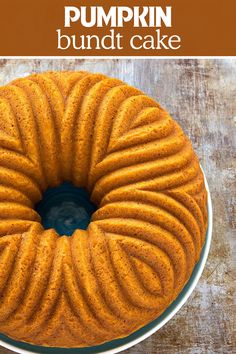 a bundt cake on a plate with the words pumpkin bundt cake above it