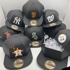 six new york yankees hats are on display in a hat box, with the number eight