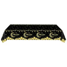 a black table cloth with gold stars and crescents on the top, sitting in front of a white background