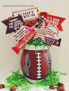 a football themed candy bar arrangement in a vase