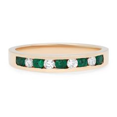 Clean and simple, this fabulous channel set band ring is encrusted with 5 round cut emeralds and 4 round brilliant cut diamonds. Total diamond weight: 0.20 carat. Total emerald weight: 0.25 carat. Crafted in 14k yellow gold. Ring size 6.25. Width: 3.2 mm. Weight: 2.33 grams. Excellent preowned condition. Comes with a presentable gift box. Luxury Channel Set Emerald Ring For Engagement, Luxury Elegant Channel Set Emerald Ring, Luxury Classic Emerald Ring Channel Set, Luxury Formal Emerald Ring Channel Set, Luxury Green Diamond Ring With Channel Set, Luxury Green Diamond Ring Channel Set, Channel Set, Green Emerald, Yellow Gold Ring