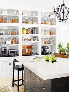 a kitchen filled with lots of open shelves