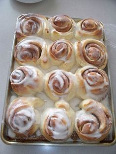 a pan filled with cinnamon rolls sitting on top of a counter next to an instagram page