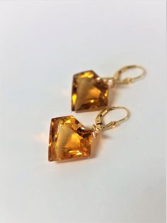 "Beautiful Shield Cut Orange Citrine Gemstones and 14K Gold Filled Drop and Dangle Earrings. These outstanding Dangles have Shield Cut Orange Citrine Gemstones. Beautifully colored Orange Citrine Gemstones that measure 19.1 mm long x 20.8 mm wide x 10.7 mm deep. These stones are 39.60 carats in weight and are stones are IF (internally Flawless). They are large impressive Citrine Stones.These Gemstones have the most beautiful Fire and Sparkle. These earrings come with soft silicone earring backs. Orange And Gold Jewelry, Elegant Formal Citrine Earrings, Formal Orange Gemstone Earrings, Elegant Orange Earrings For Formal Occasions, Yellow Briolette Earrings For Formal Occasions, Yellow Gemstone Earrings For Wedding, Elegant Citrine Teardrop Earrings, Elegant Teardrop Citrine Earrings, Formal Amber Citrine Earrings