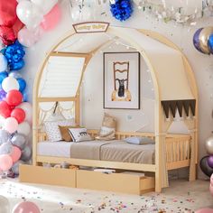 a bedroom decorated with balloons and confetti