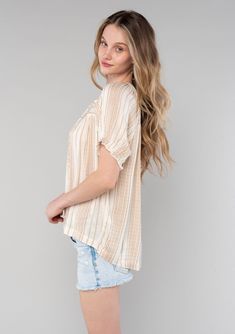 A classic bohemian puff sleeve top in a neutral tan stripe. Neutral stripe Relaxed fit Short raglan puff sleeves Elastic cuffs Hip length Split v-neckline with ties Classic bohemian blouse Charming puff sleeves add a whimsical touch to this classic spring bohemian top. Designed in a versatile and chic neutral tan stripe, with a flowy, lightweight silhouette that is perfect for warmer days. Model is 5'10, wearing a size S.Style: I-15029W-RPN Spring Striped Puff Sleeve Tops, Striped V-neck Relaxed Fit Blouse, Striped V-neck Blouse With Relaxed Fit, Striped Relaxed Fit V-neck Blouse, Striped Puff Sleeve Top For Summer, Casual Neutral V-neck Blouse, Casual V-neck Neutral Blouse, Beige V-neck Peasant Top For Spring, Affordable Boho