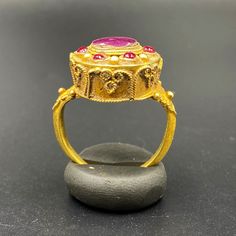 The Beautiful Antique Gold Ring Probably From South East Regions. Beautiful Ruby Light Gems Stone Is Place In The Ring. Size Details Pictures Are Listed Above. The Size Of This Ring Is USA 7. The Weight Is 8.11 Grams. 18 karat Gold .Test Certificate Available On Request Of Customer. Free And Fast Shipping World Wide. Traditional Ruby Ring In Yellow Gold, Ceremonial Multi-stone Ring Jewelry, Ceremonial Multi-stone Jewelry Ring, Traditional Oval Ring With 17 Jewels, Yellow Gold Temple Jewelry Rings For Formal Events, Byzantine Gemstone Jewelry For Weddings, Formal Yellow Gold Temple Jewelry Rings, Traditional Multi-stone Oval Rings, Traditional Oval Multi-stone Rings